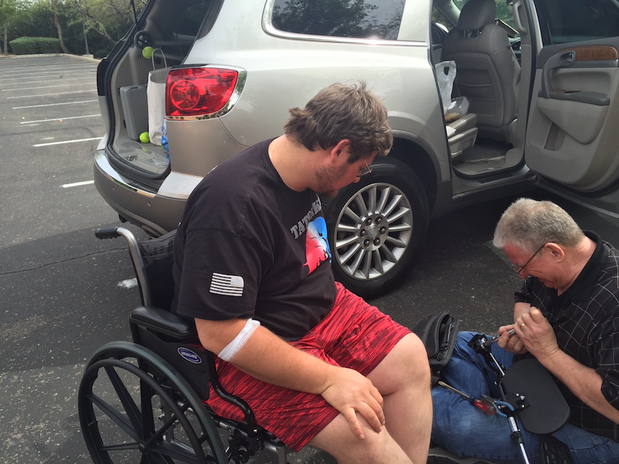Fixing Jon's new wheelchair in the hotel parking lot